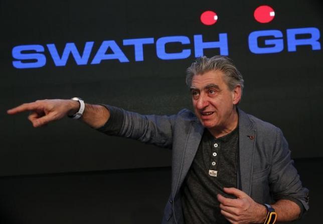 Swatch Group CEO Hayek poses with the new 'Swatch Touch Zero One' during the Swiss watchmaker's annual news conference in Corgemont