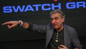 Swatch Group CEO Hayek poses with the new 'Swatch Touch Zero One' during the Swiss watchmaker's annual news conference in Corgemont