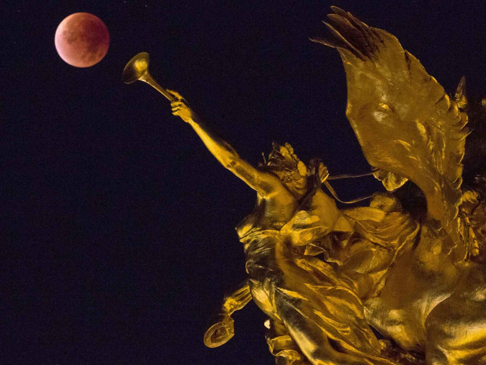 Artística imagen de la luna roja en París, entre las esculturas del Puente de Alejandro III.