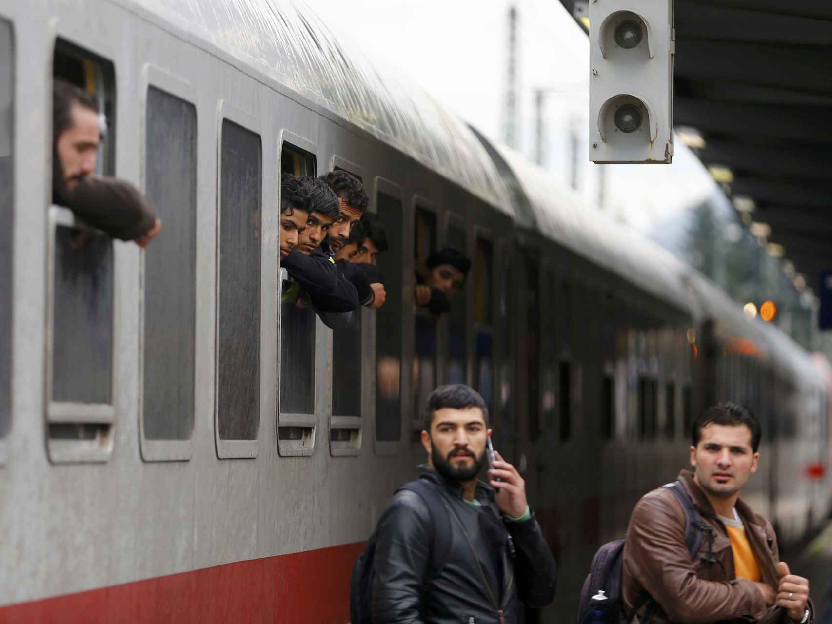 Los migrantes se asoman por la ventana de un tren a su llegada a Freilassing, Alemania.