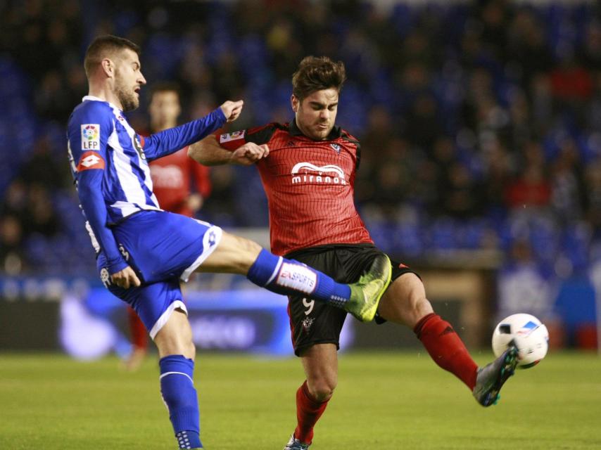 El delantero del Mirandés Prats pelea un balón con Lopo del Deportivo.