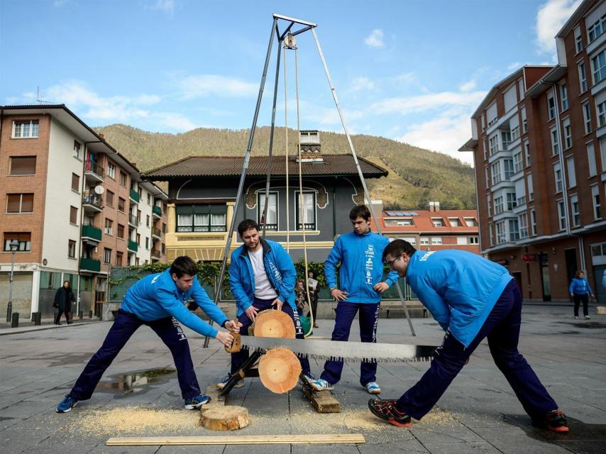 Jóvenes vascos cortando un tronco.