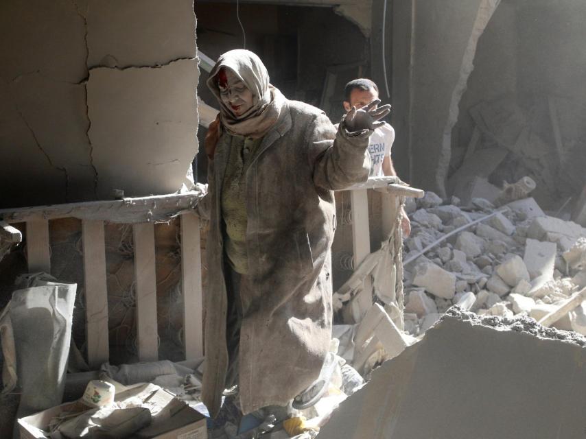 Unas mujeres se asoman a un balcón tras los bombardeos sobre un área controlada por la oposición.