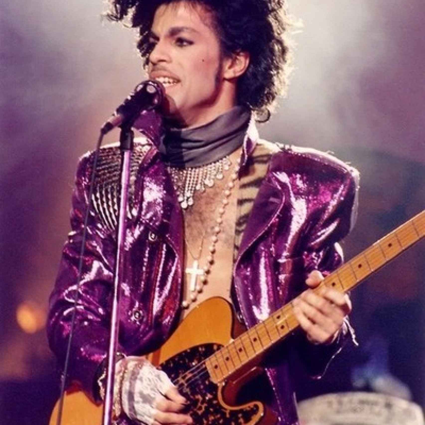 Prince vestido de morado interpretando Purple Rain
