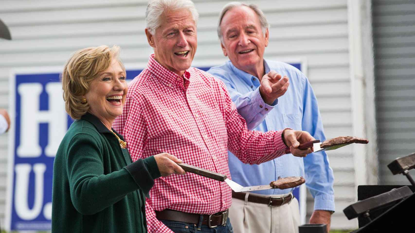 Bill Clinton y su mujer Hillary cocinando unas hamburguesas