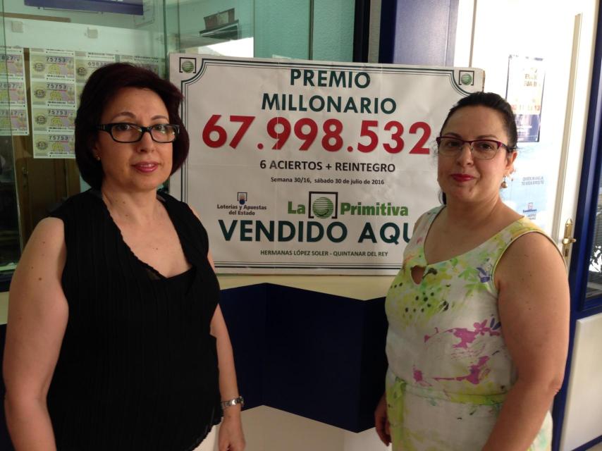 Josefa (izquierda) y Esther, junto al letrero que anuncia el premio dado en su administración.