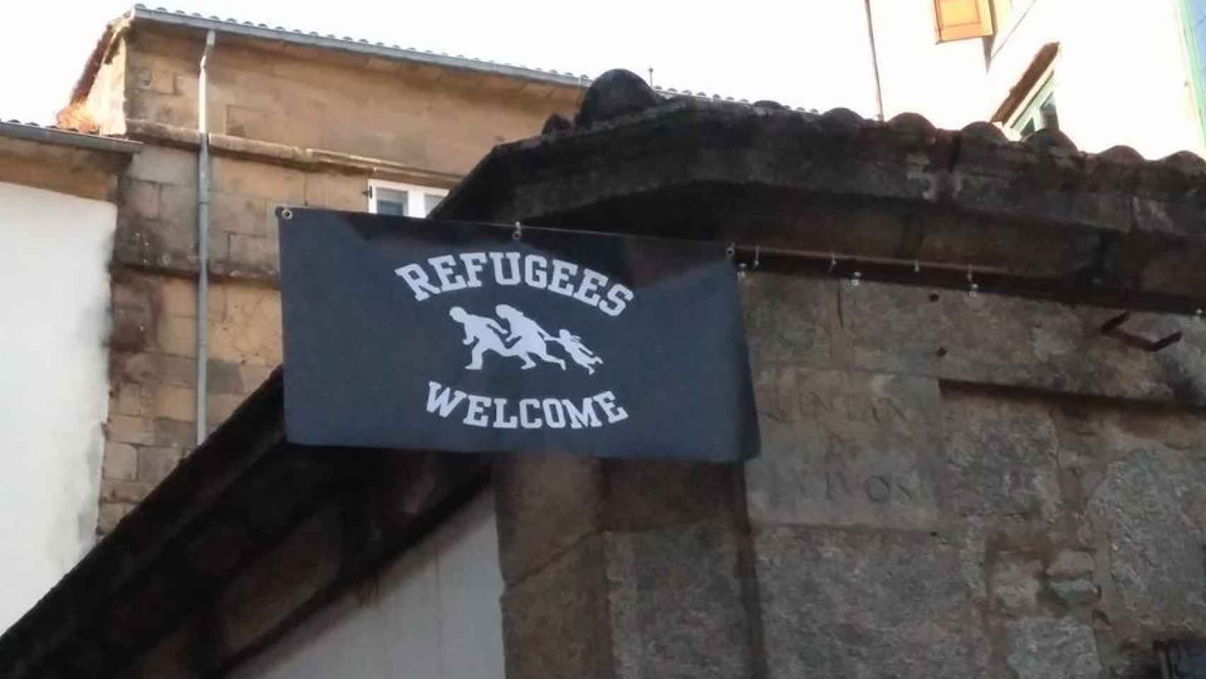 El cartel que da la bienvenida a los refugiados en la puerta del Café Literarios.