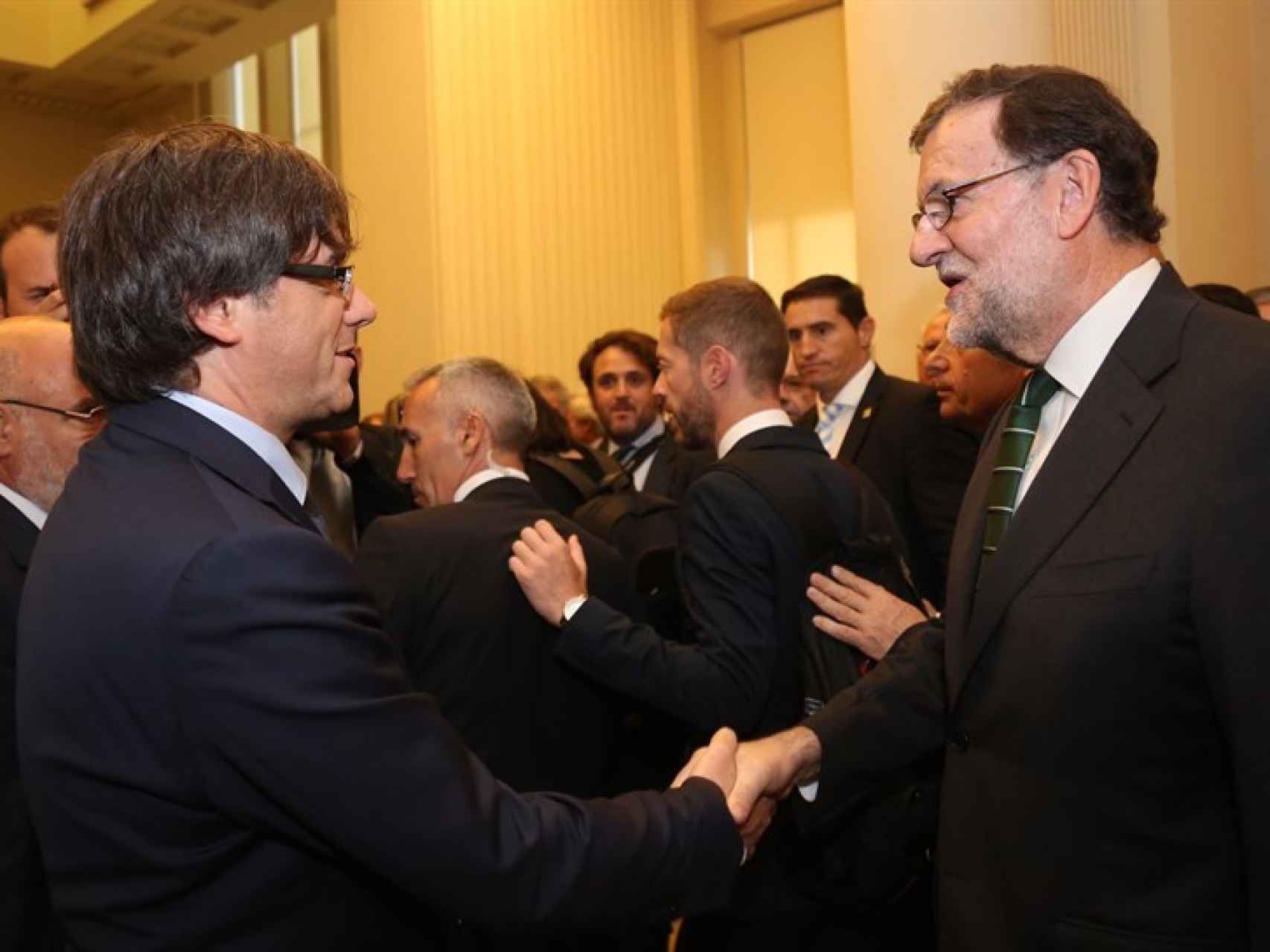 Imagen del saludo cordial entre Puigdemont y Rajoy este viernes.