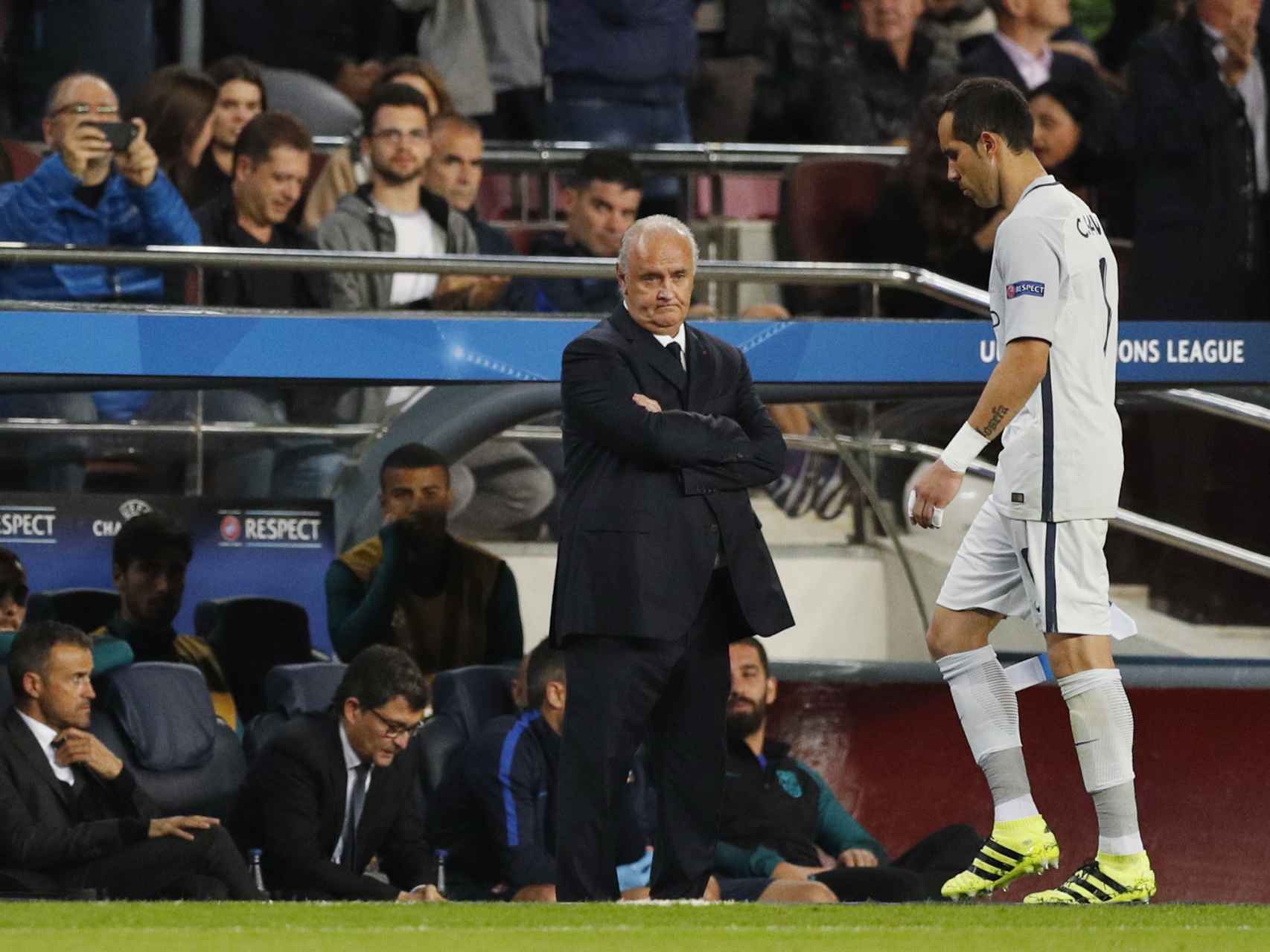 Manchester City's Claudio Bravo walks past Barcelona coach Luis Enrique looking dejected after being sent off