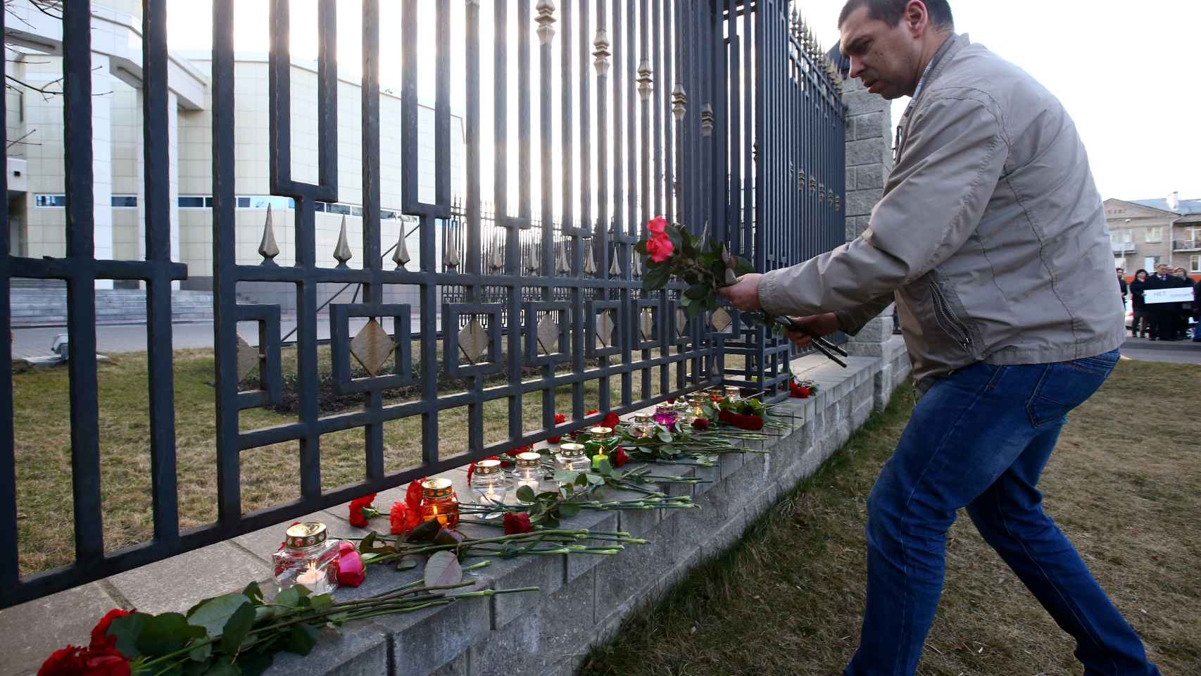 Un hombre deja una ofrenda floral en la embajada rusa de Minsk, en Bielorrusia.