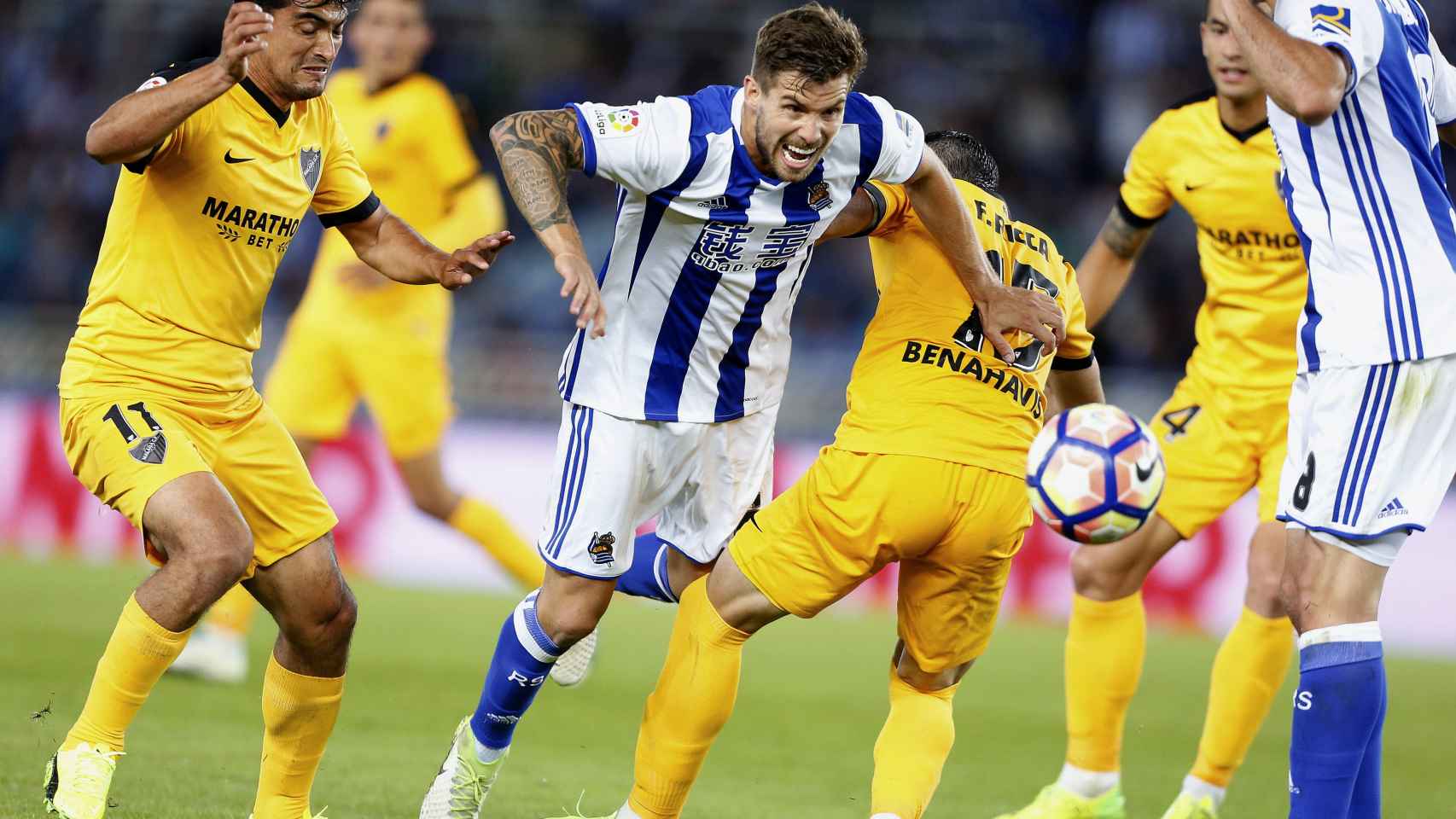 El defensa de la Real Sociedad, Íñigo Martínez, entre jugadores del Málaga.