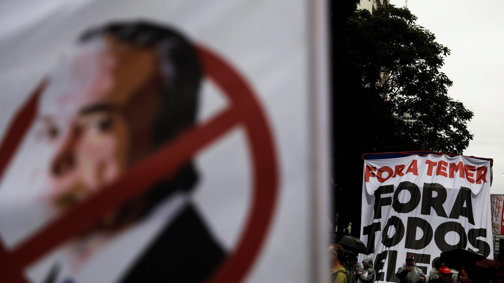 Manifestantes portan pancartas en contra de Temer.