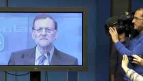 Rajoy declarando ante los medios de comunicación a través de un plasma