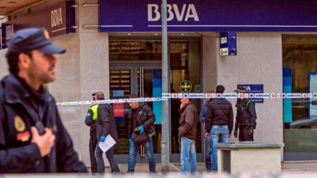 Agentes de la Policía Nacional junto a una oficina del BBVA atracada.