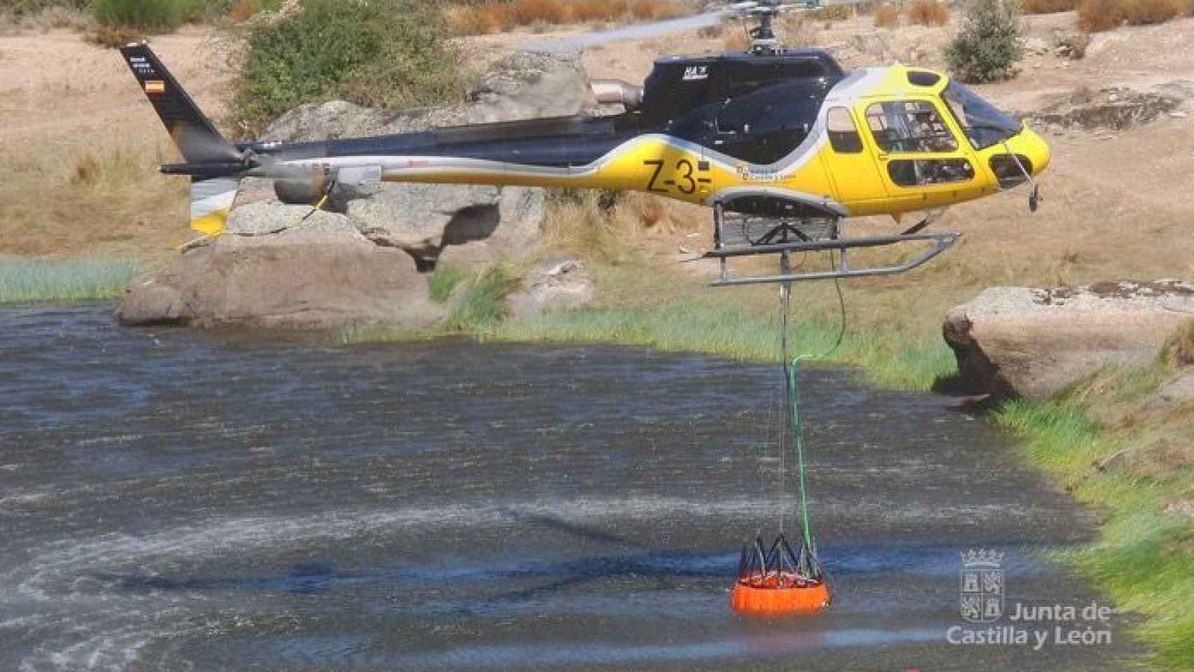 Un helicóptero de extinción de incendios tomando agua