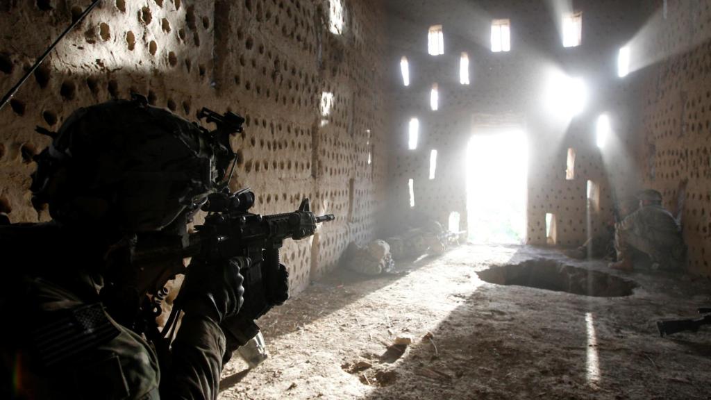 Un soldado estadounidense apunta su rifle a una entrada después de ser atacado por los talibanes en Afganistán.