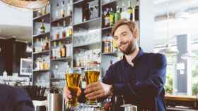 Barman serving beer in a pub