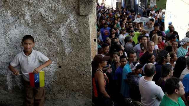 Una larguísima cola de venezolanos espera su turno para votar en los comicios regionales.