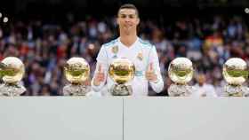 Cristiano posa con sus cinco balones de oro en el Santiago Bernabéu