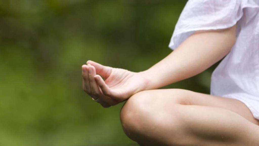 Una mujer realiza una sesión de meditación.