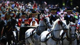 Los recién casados desfilando en el coche de caballos.