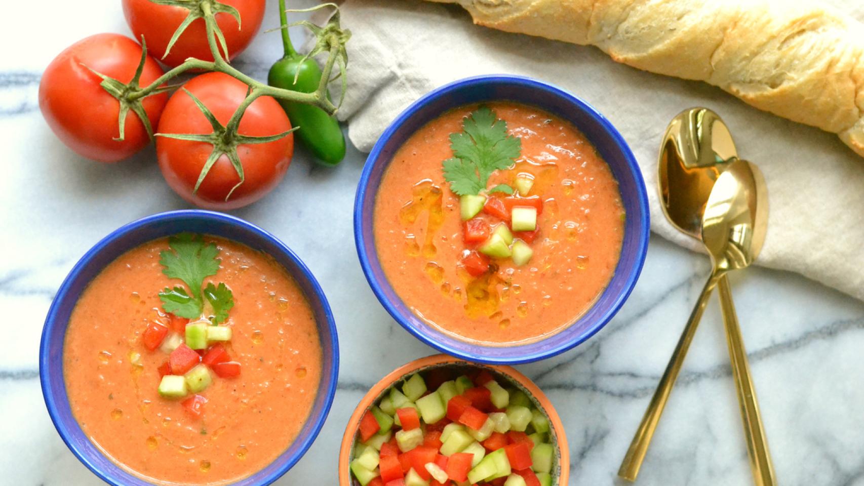 Dos platos de gazpacho, con sus trozos de pimiento y su pepino.