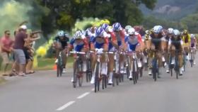 Un espectador lanza una bengala sobre el pelotón del Tour.