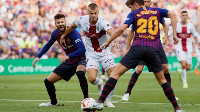 Piqué y Sergi Roberto pelean un balón con Longo