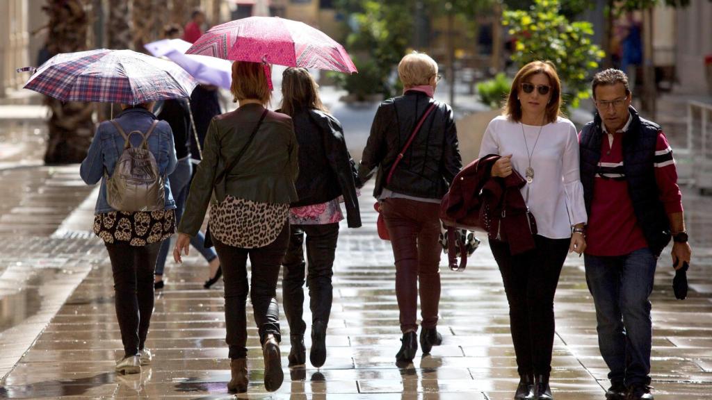 Varias personas pasean este sábado por la tarde en Málaga.