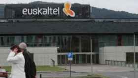 Dos personas  pasean ante unas oficinas de Euskaltel.