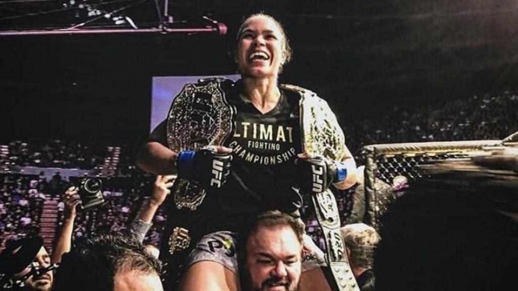 Amanda Nunes con sus dos títulos. Foto: Twitter (@Amanda_Leoa)