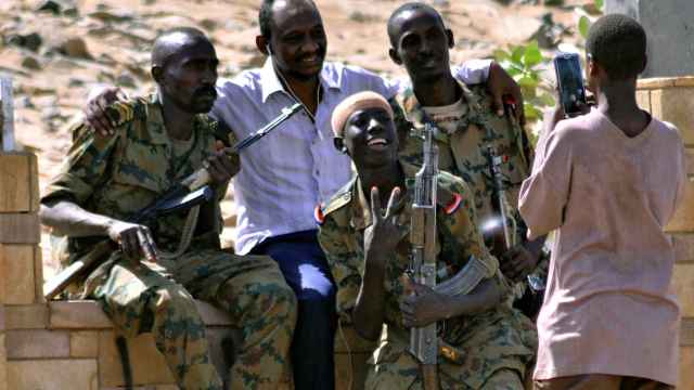 Varios militares sudaneses celebran el cesde del toque de queda.