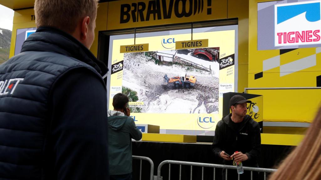 Organización del Tour presenciando los trabajados de excavadoras sobre la carretera.