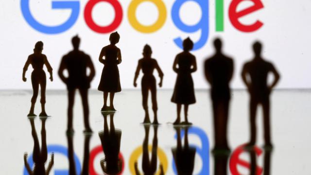 FILE PHOTO: Small toy figures are seen in front of Google logo in this illustration picture