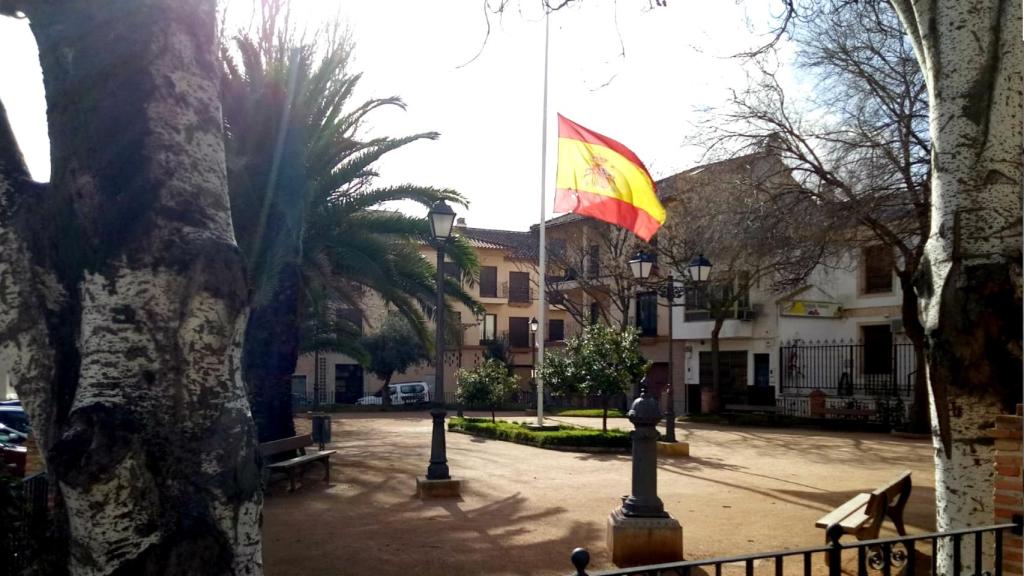 La bandera española ondea a media asta en la Plaza de la Constitución.