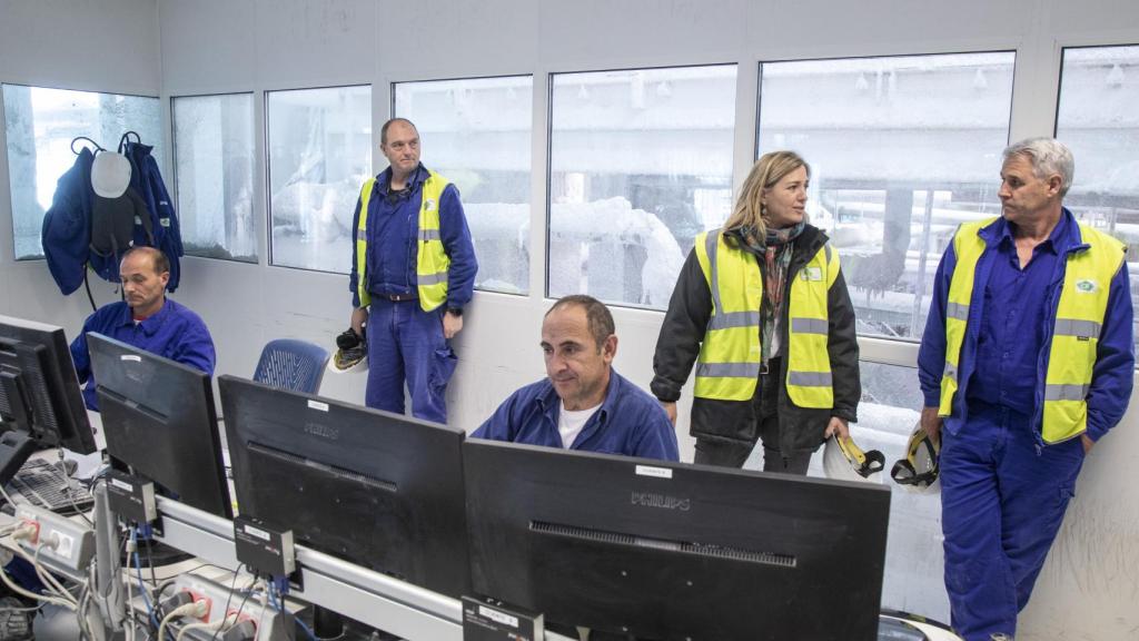 Victoria Plantalamor junto a uno de los encargados de la mina, Marce, en la sala de control de la planta.