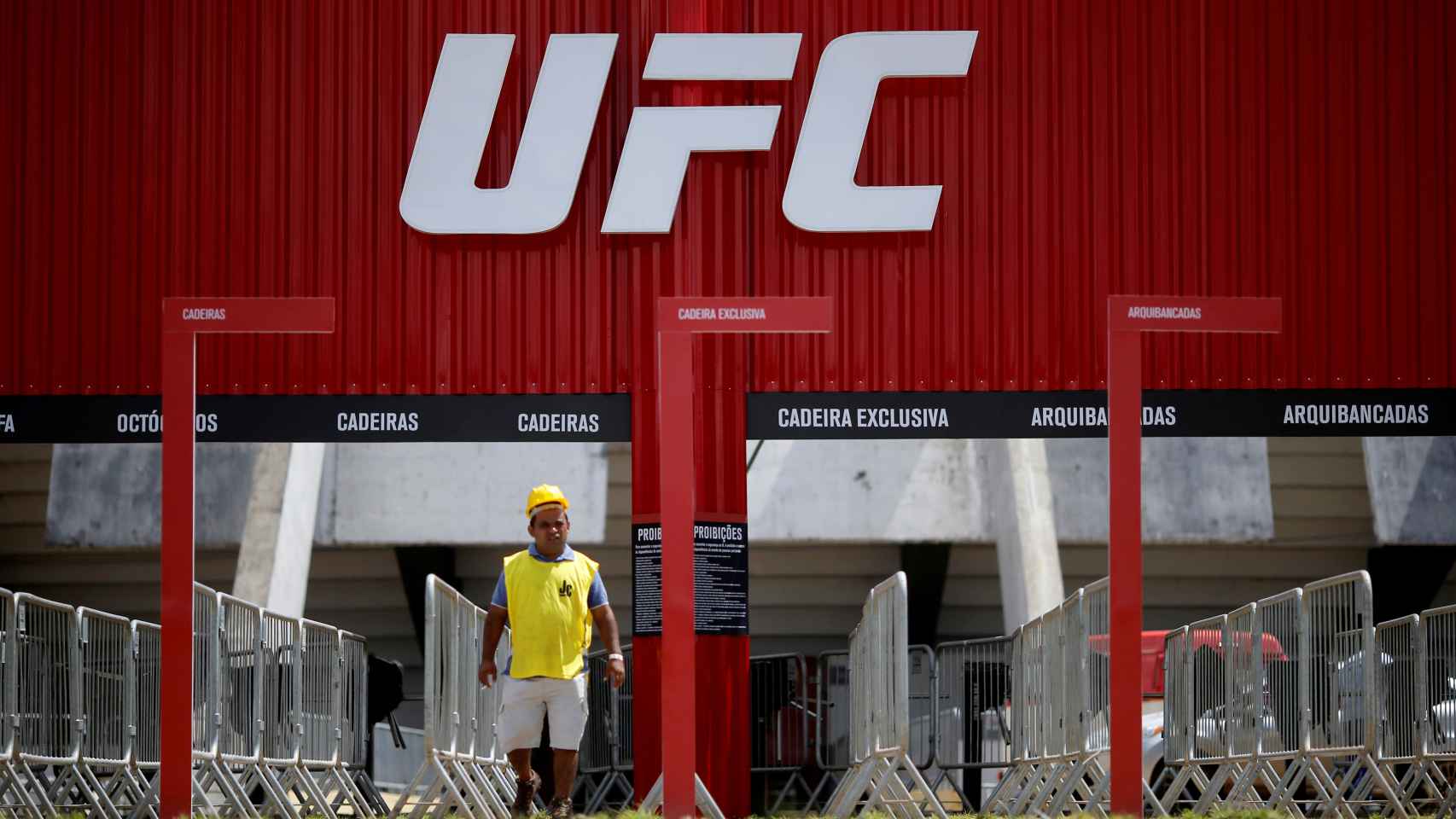 FILE PHOTO: A man walks in front of the Nilson Nelson Gymnasium as the next UFC Fight Night will be held without fans during the fights, after reports of the coronavirus in Brasilia