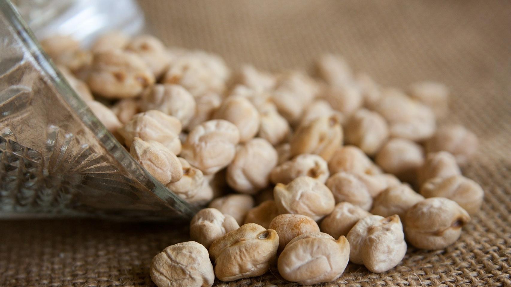 Unos garbanzos esparcidos encima de la mesa.