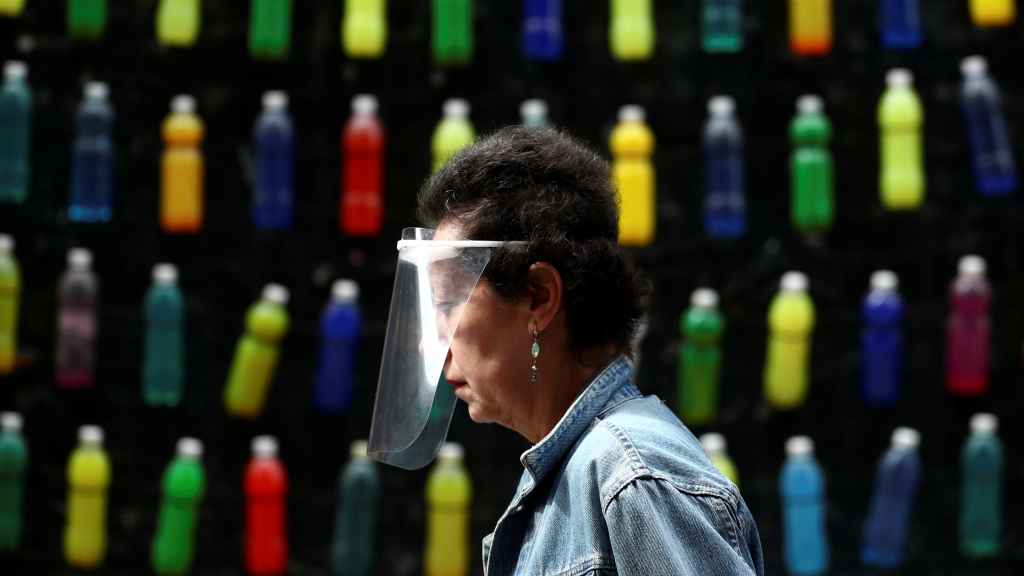 Una mujer pasea en Madrid con una máscara protectora.