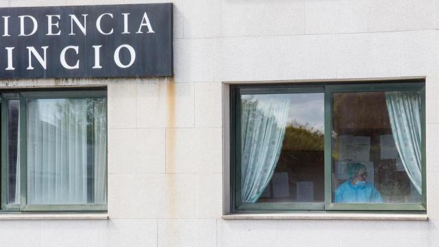 Una sanitaria en una ventana de la residencia de ancianos de O Incio, en Lugo.