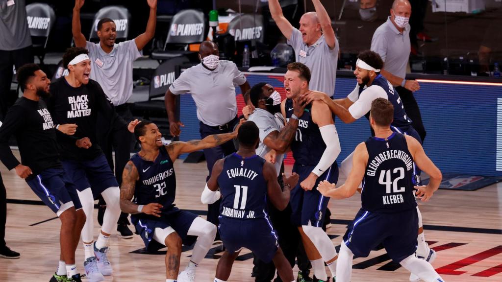 Luka Doncic celebra con sus compañeros su canasta