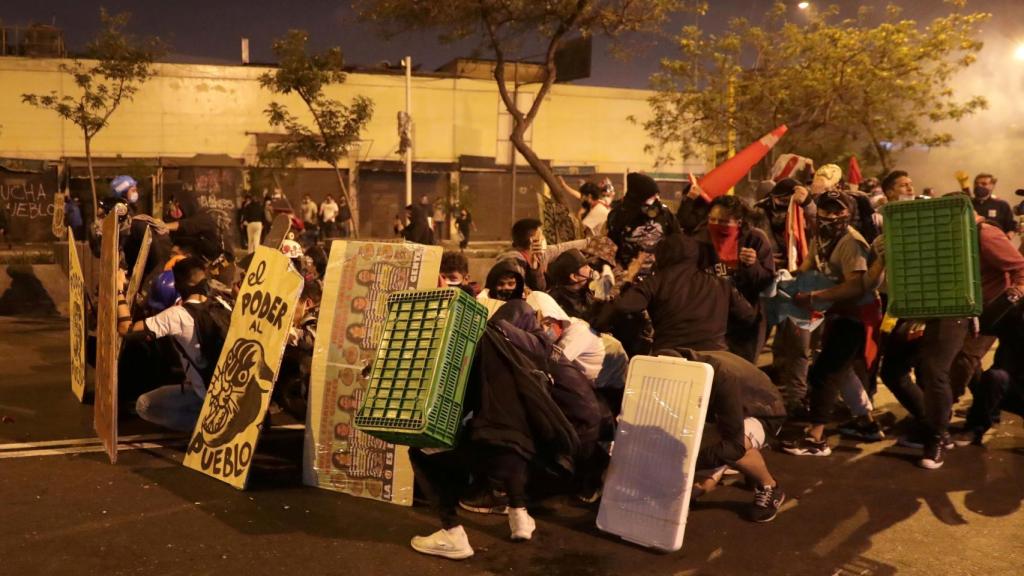 Los manifestantes hacen una barricada.