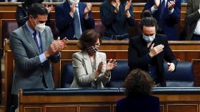 Pedro Sánchez aplaude a la ministra de Hacienda tras la votación de los Presupuestos.