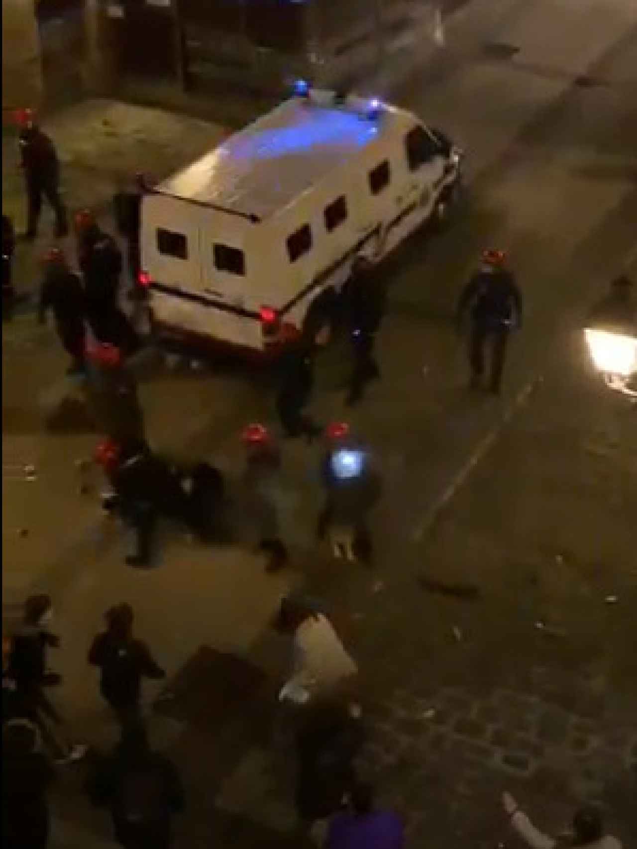 Un grupo de ertzainas repele el ataque de unos jóvenes que estaban participando en un botellón en Bilbao.