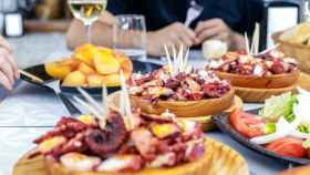 People,Eating,Pulpo,A,La,Gallega,With,Potatoes.,Galician,Octopus