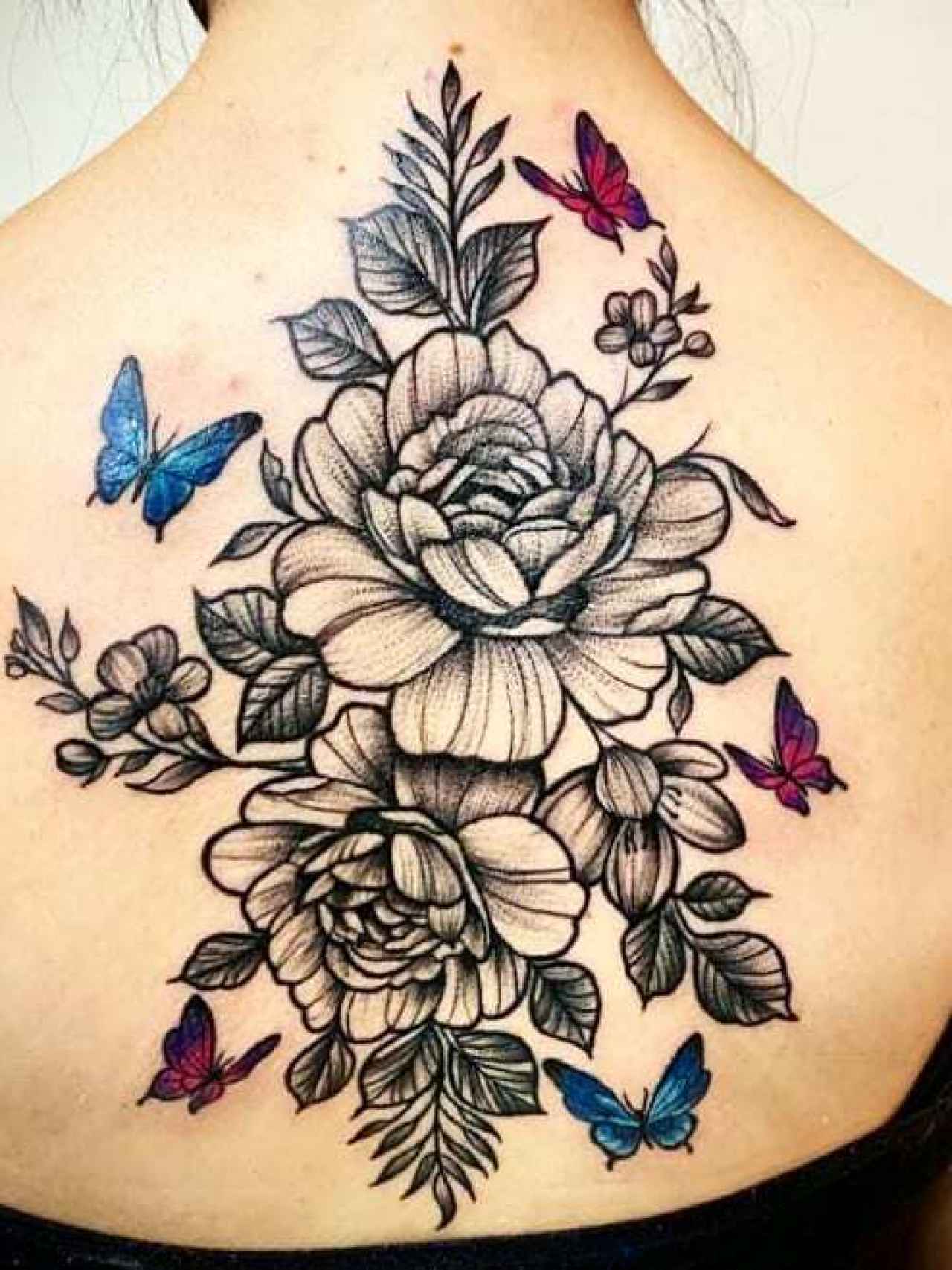 Espalda tatuada con motivos florales.