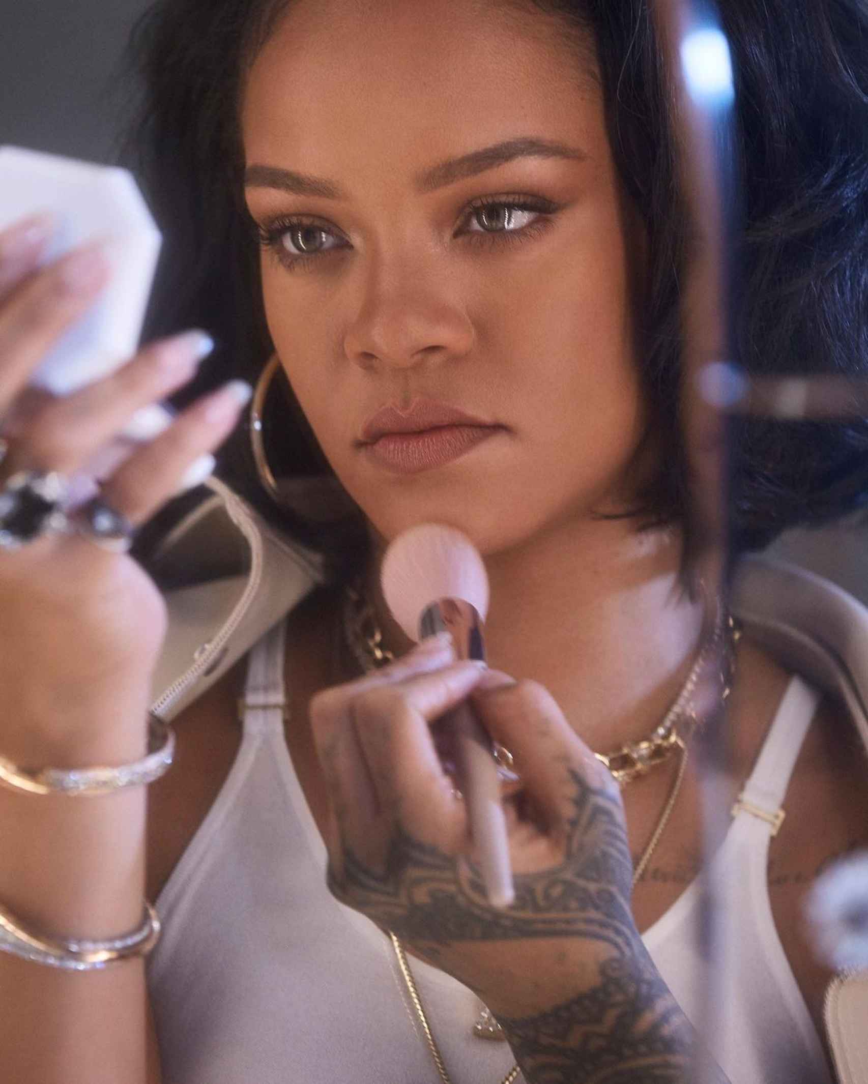 Rihanna, maquillándose con sus productos de Fenty Beauty.