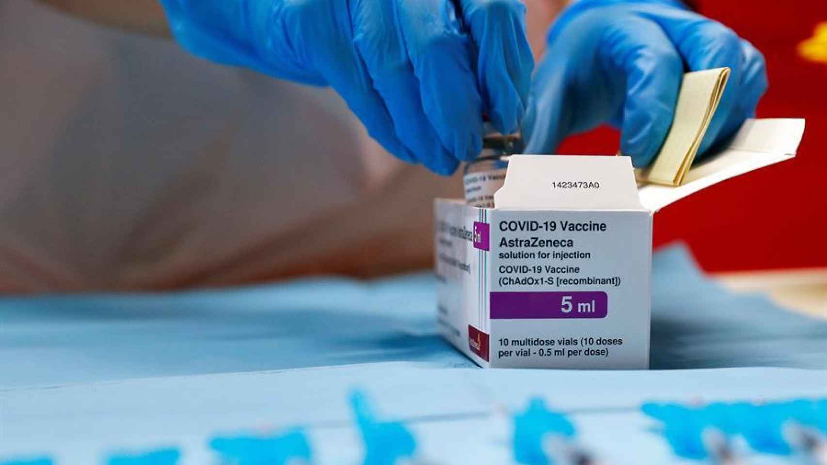 Un sanitario abriendo una caja de vacunas de AstraZeneca.