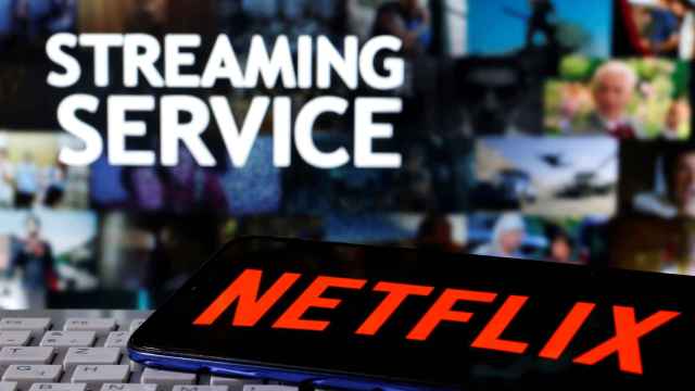 FILE PHOTO: A smartphone with the Netflix logo is seen on a keyboard in front of displayed Streaming service words in this illustration