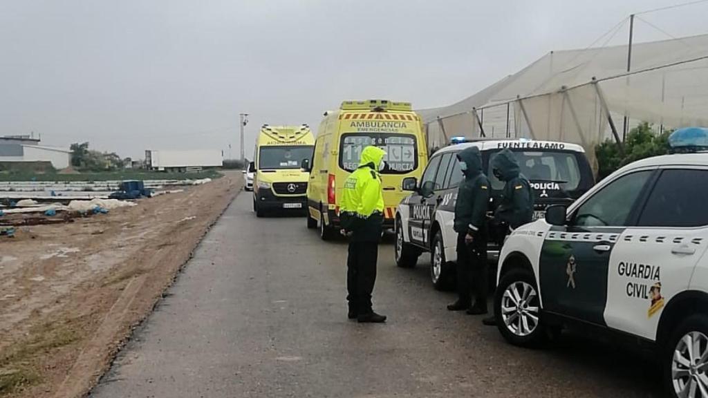 Un policía local y guardias civiles junto a la finca agrícola donde se produjo el accidente laboral.